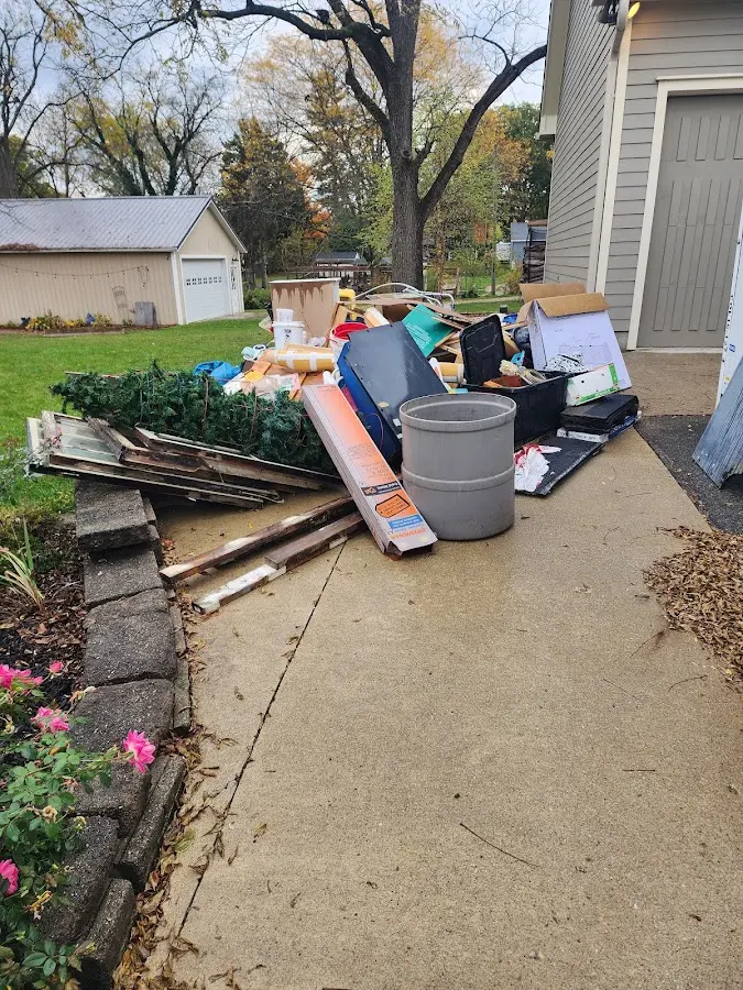 Dumpster being loaded with debris for Estate Cleanout Dumpster Rental in High Bridge